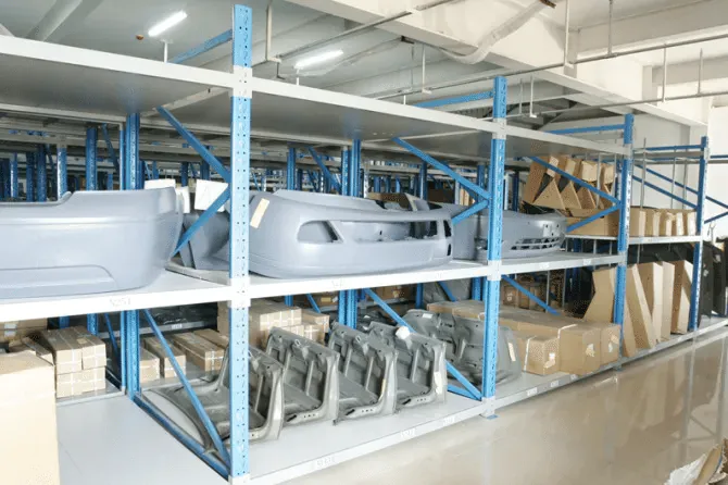 Sorted auto body panels and bumper covers arranged on warehouse shelves